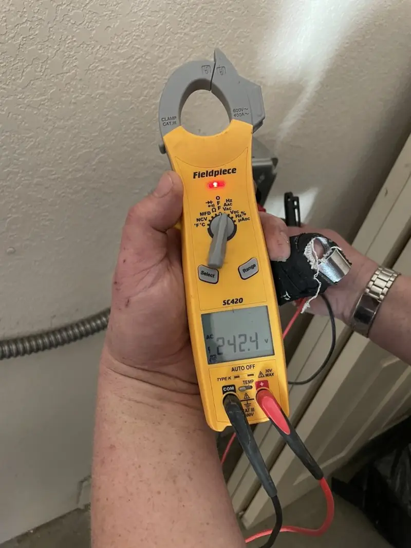 Voltage testing with clamp meter during Whole House Surge Protector in Bedford